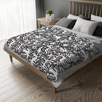 White hand-drawn folk art animals and plants printed on a lightweight, soft and plush two-sided velveteen throw blanket.