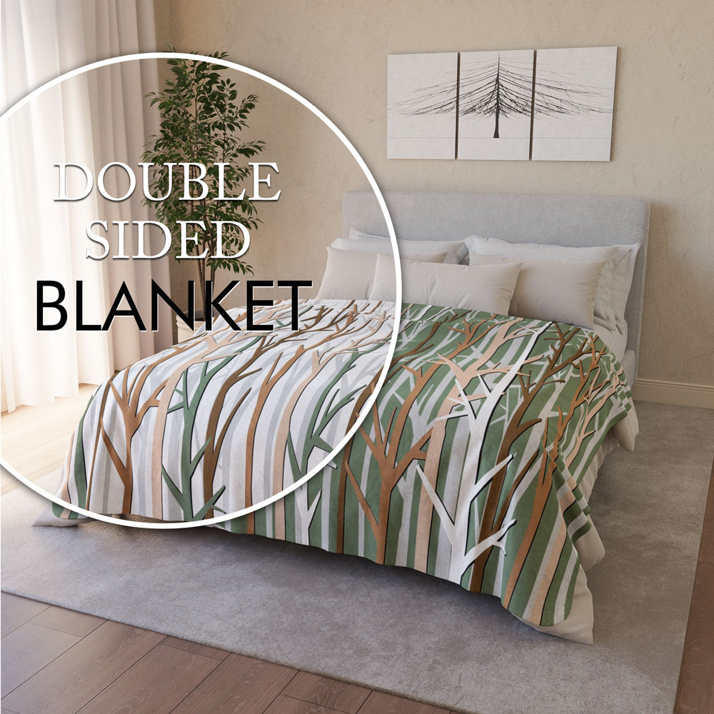 A graphic art winter forest design in an earthy color palette of tan, brown, sage green and white, printed on a lightweight, soft and plush two-sided velveteen throw blanket. One side is printed on a white background and the other side is printed on a green background.