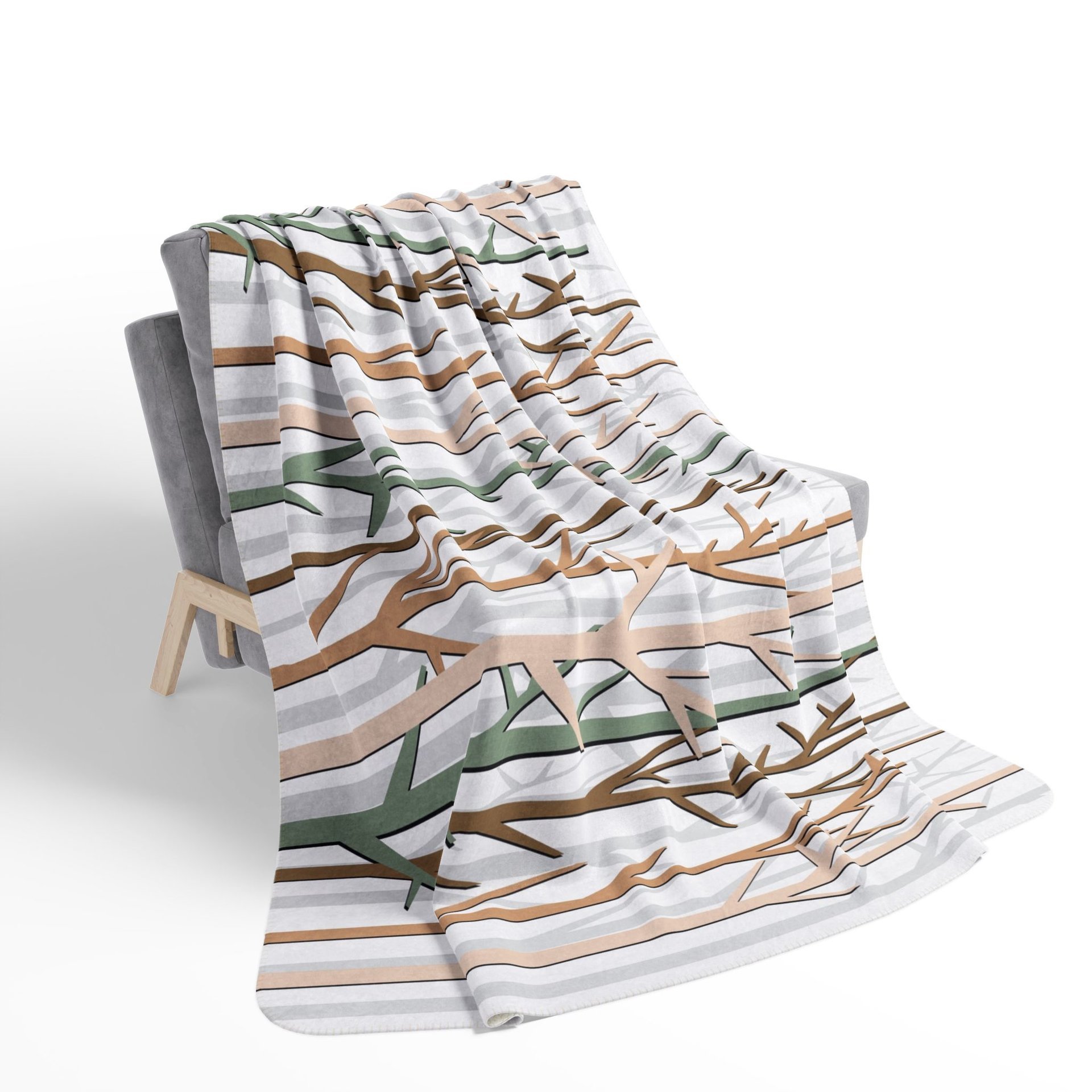 winter forest design blanket in an earthy color palette of tan, brown, sage green and white on a chair