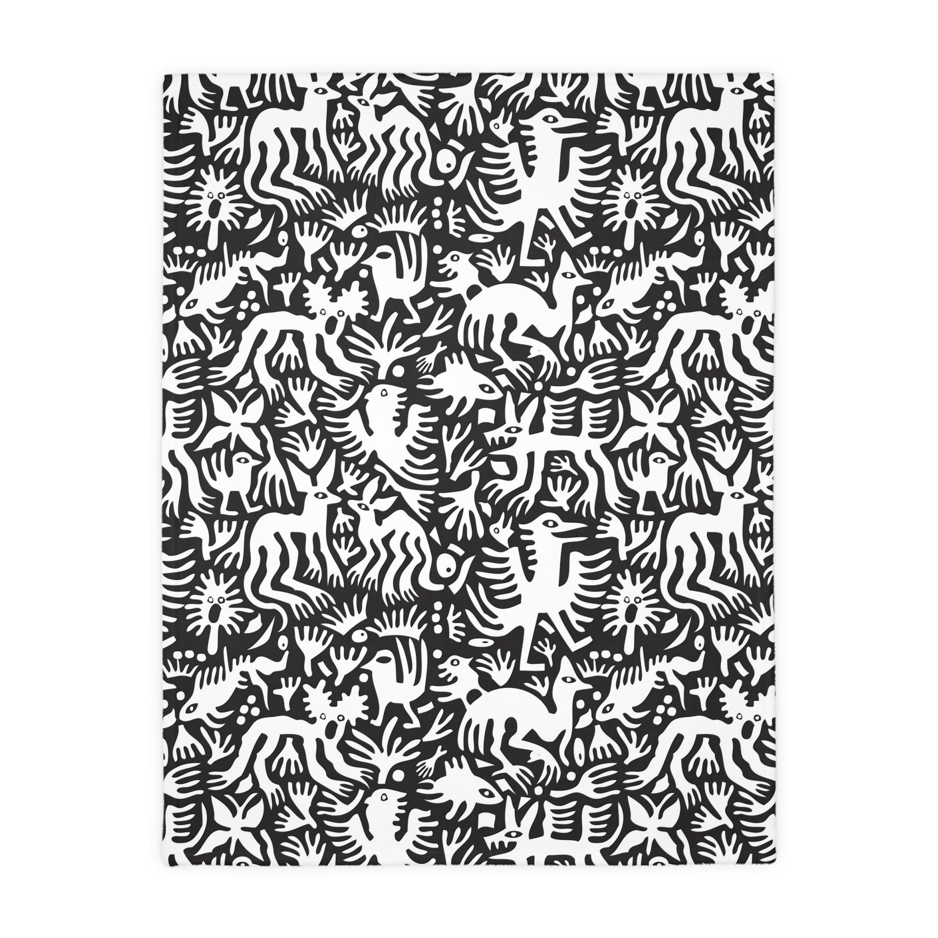 Black side. White hand-drawn folk art animals and plants printed on a lightweight, soft and plush two-sided velveteen throw blanket.