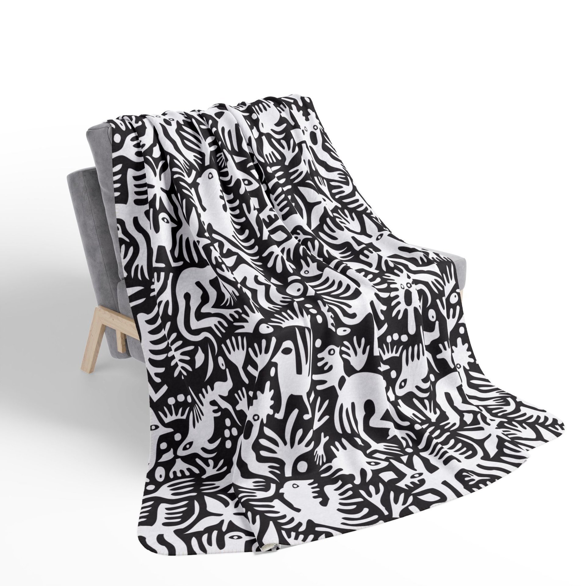 White hand-drawn folk art animals and plants printed on a lightweight, soft and plush two-sided velveteen throw blanket.