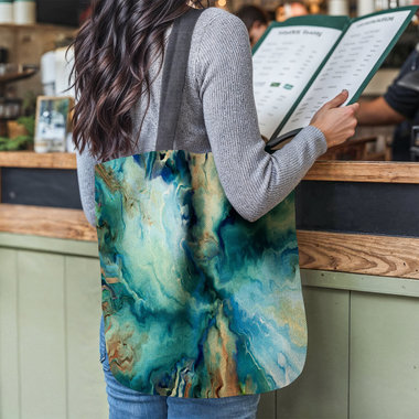 Blue Abstract Tapestry Bag, Fluid Art Woven Tote hanging from the shoulder of a young woman who is reading a menu at the counter of a restaurant.