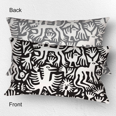 Lumbar pillow, Primitive white hand-drawn animals and plant life. One side is printed on a black background and the other side is printed on a gray background
