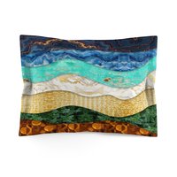 The standard pillow sham features a layered, wavy design resembling the view out to sea from the beach edge.