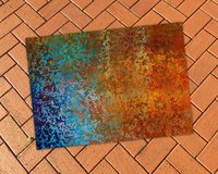 Abstract Ombré Rug in Southwestern Colors on a brick patio