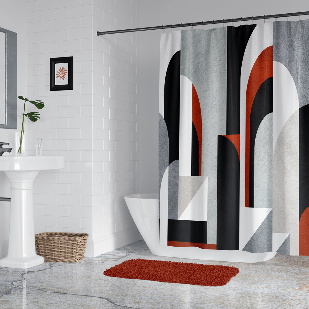 This shower curtain features an abstract geometric design with muted colors, primarily gray, black, white, and red-brown, arranged in a textured architectural pattern of arcs and rectangle shapes.