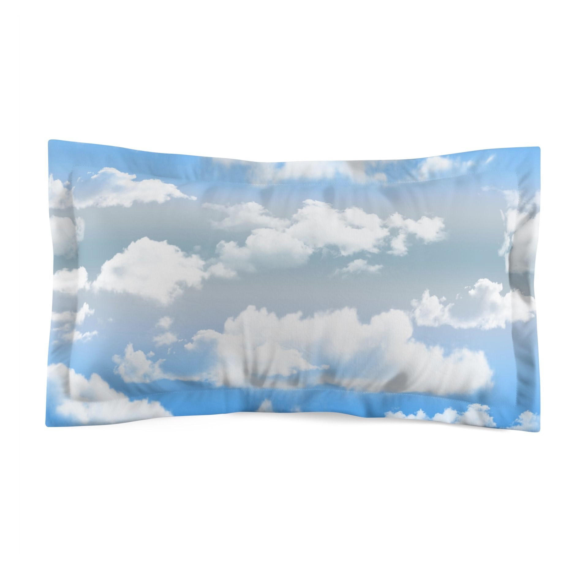 King pillow sham printed with fluffy white clouds on a blue and gray ombré sky background.